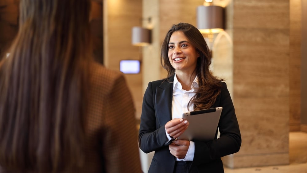 a woman interacting a female customer, real estate