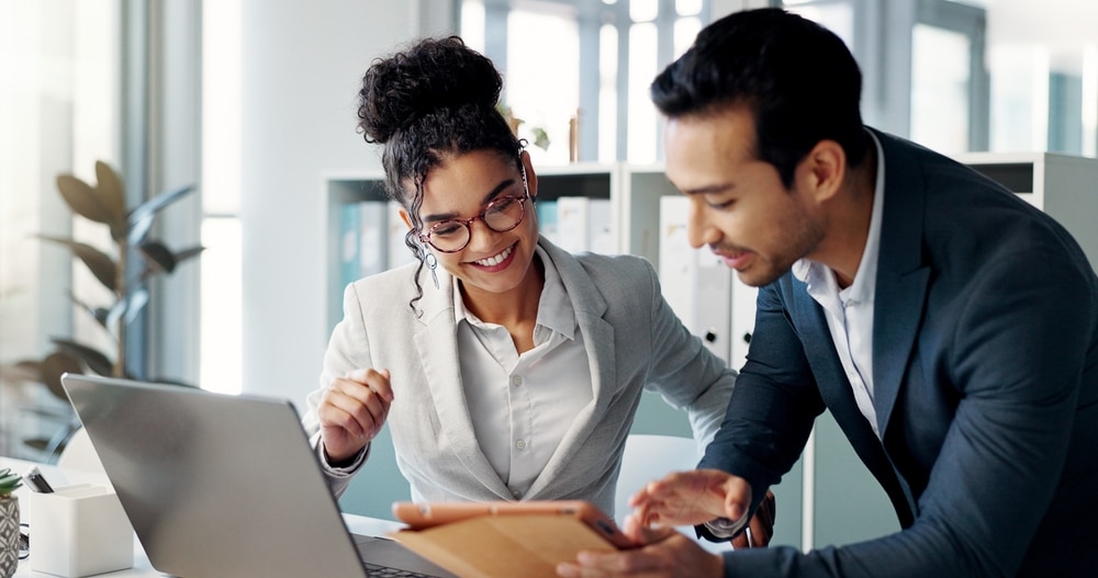 a man holding a laptop discussing to a woman beside him, Marketing agencies
