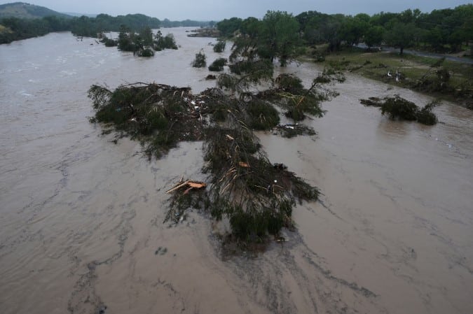A wide, muddy river with debris from a Texas flood. Get an accounting virtual assistant