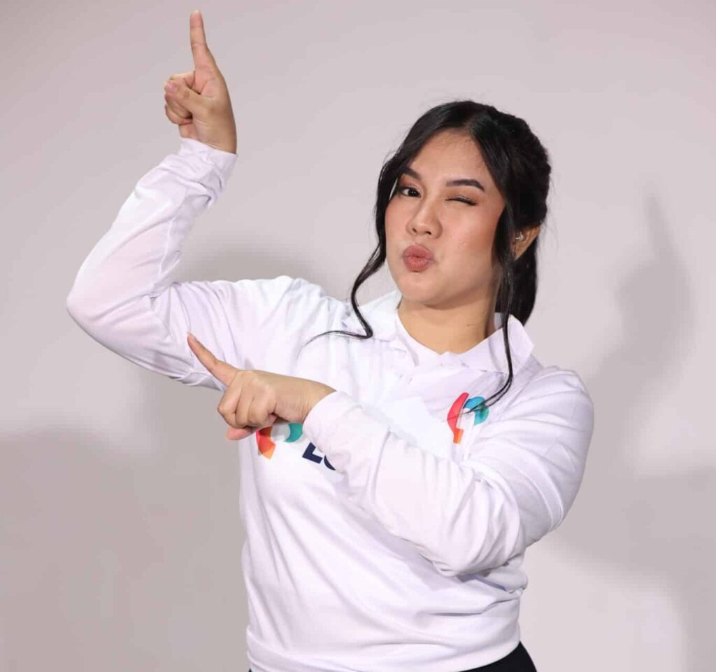Playful woman pointing, symbolizing dynamic operations assistant work.