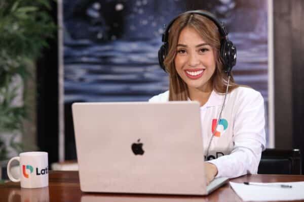 Smiling woman, a Legal Assistant and Paralegal, with headphones at a laptop, ready to assist