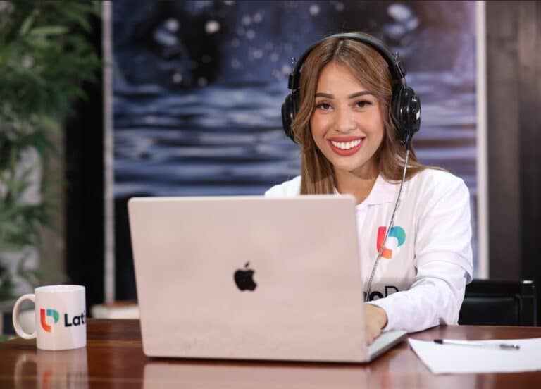 Smiling woman, a Legal Assistant and Paralegal, with headphones at a laptop, ready to assist