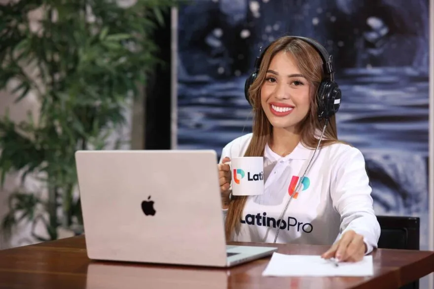 Smiling woman with headphones and branded mug, exemplifying what is a case manager.