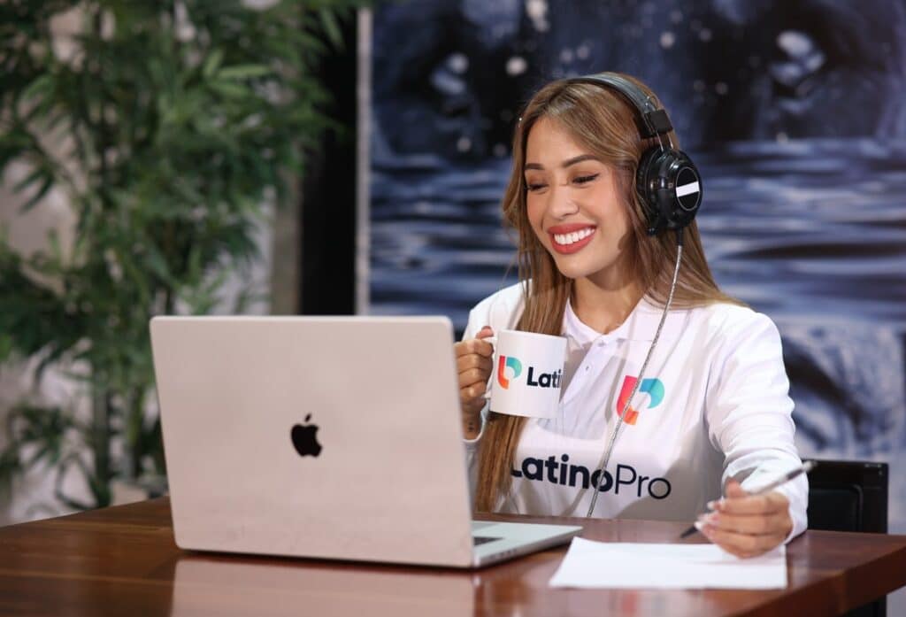 Smiling woman with headphones and laptop, demonstrating Work Excellence construction through focus and dedication