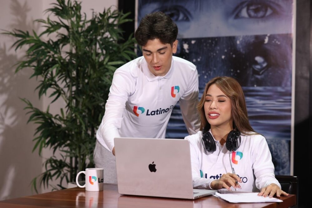 Two LatinoPro team members collaborating on a laptop, with one as an executive assistant.