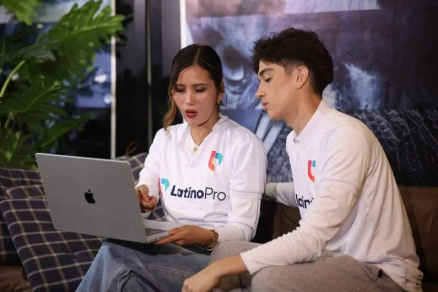 Two LatinoPro team members review data on a laptop, discussing what is case manager roles in client support strategy.