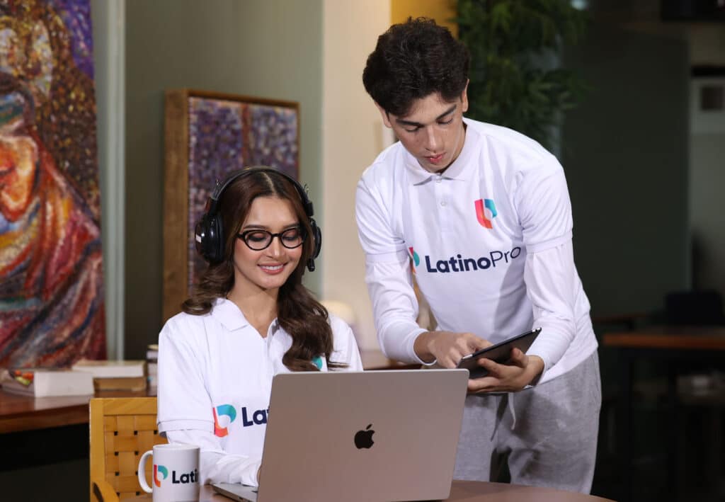 Two professionals collaborating on a laptop and tablet, ideal for virtual assistant for lead generation services.