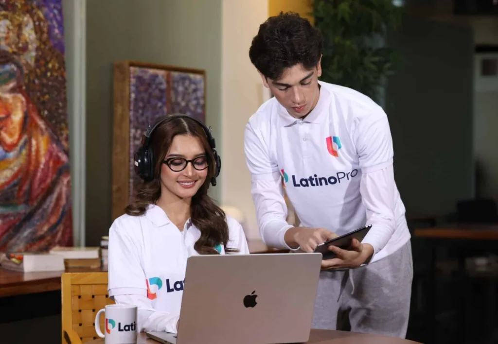 Two professionals collaborating on a laptop and tablet, ideal for virtual assistant for lead generation services.