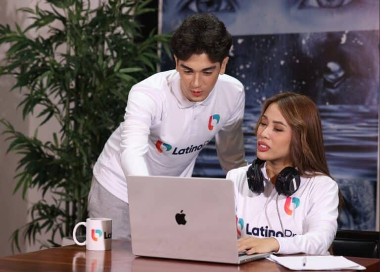 Two professionals using a laptop for virtual receptionist appointment scheduling