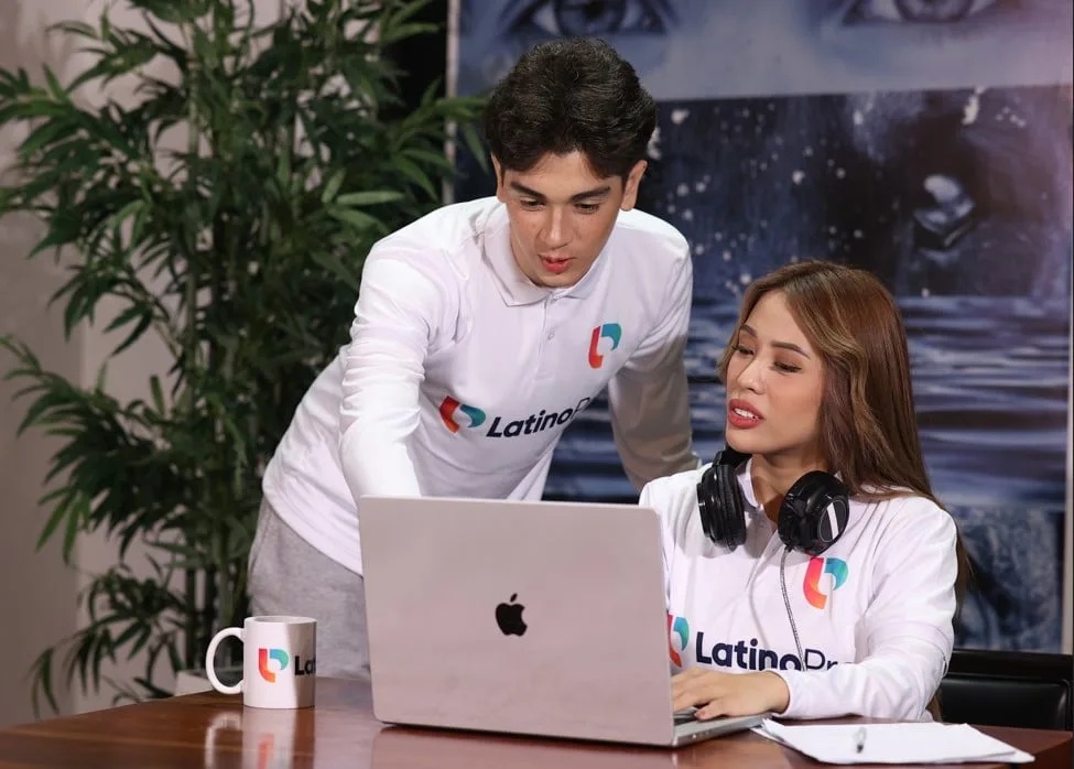 Two professionals using a laptop for virtual receptionist appointment scheduling