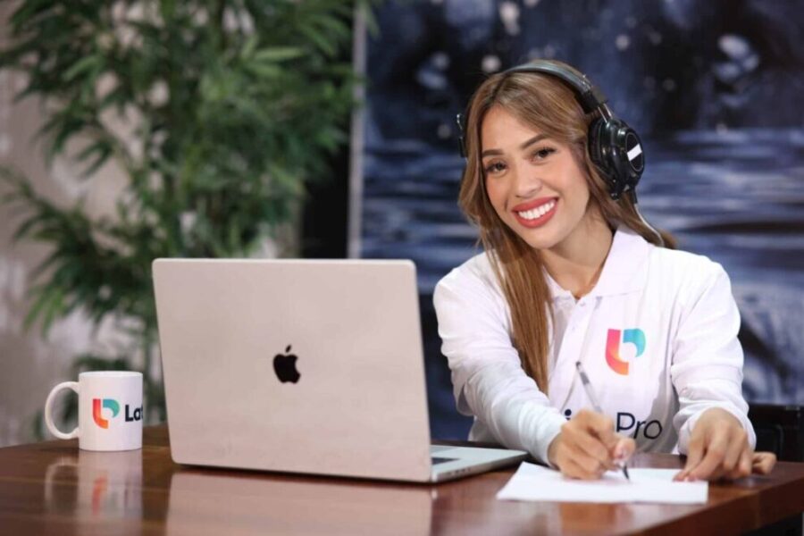 Woman smiling at desk with headphones, clarifying what does contingent mean in real estate.