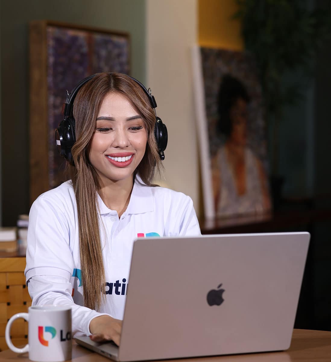 Woman working on laptop with headphones, ideal for virtual assistant for accountant services.