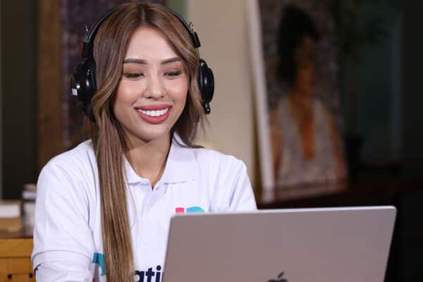 Woman working on laptop with headphones, ideal for virtual assistant for accountant services.