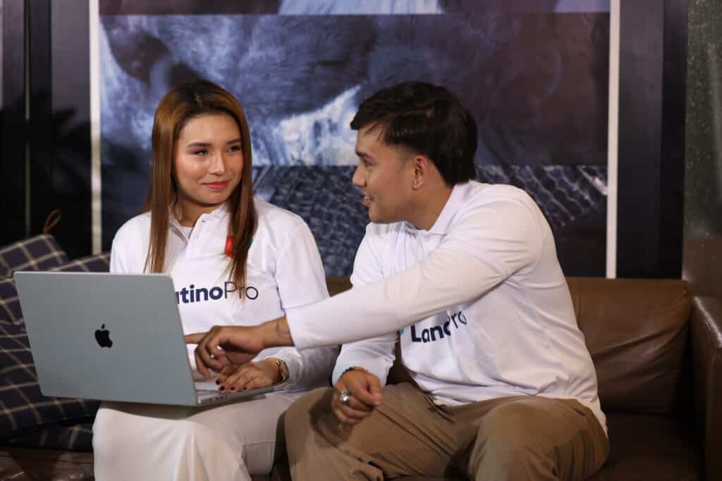 A man and woman on a couch looking at a laptop. They are learning about legal assistant training.
