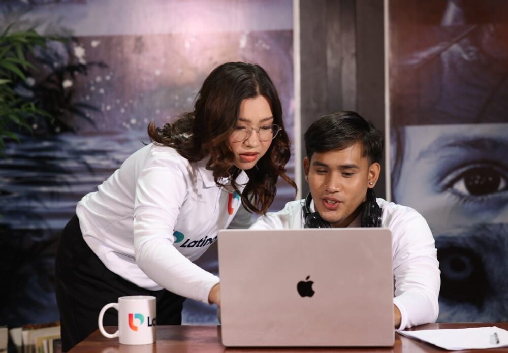 A professional legal research assistant helps a colleague with legal research on a laptop