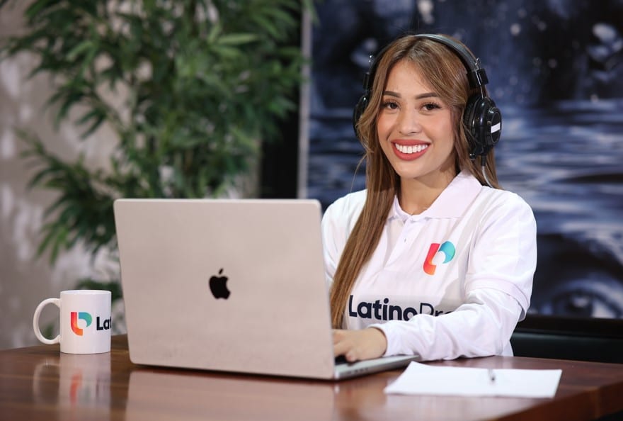 A smiling woman wearing headphones and a white polo shirt works on a laptop. Learn how do i become a legal transcriptionist