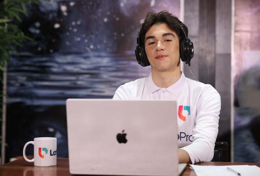 A young professional with headphones works on a laptop. Learn how to become a legal transcriptionist and start your career today