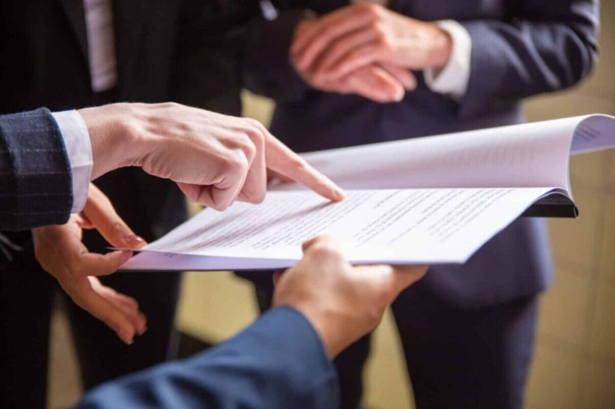 Business professionals reviewing documents together, highlighting details related to legal assistant certification.