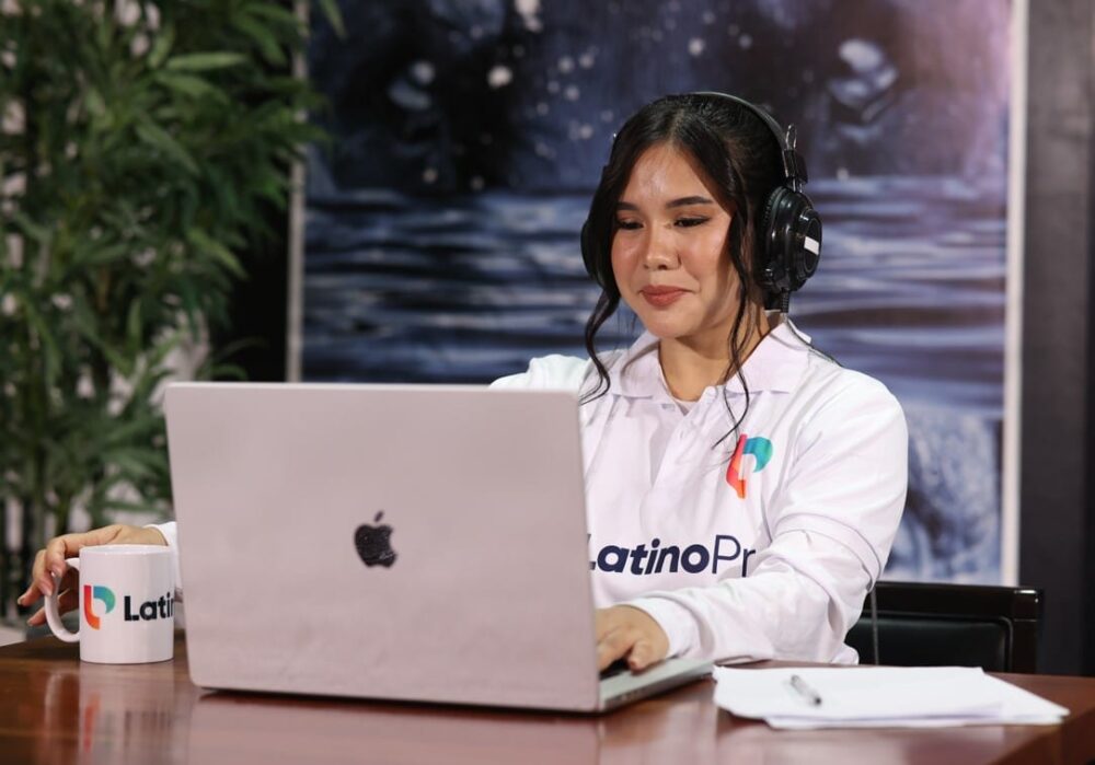 Find your next legal assistant. A woman in a headset and a LatinoPro shirt works on her laptop at a desk.