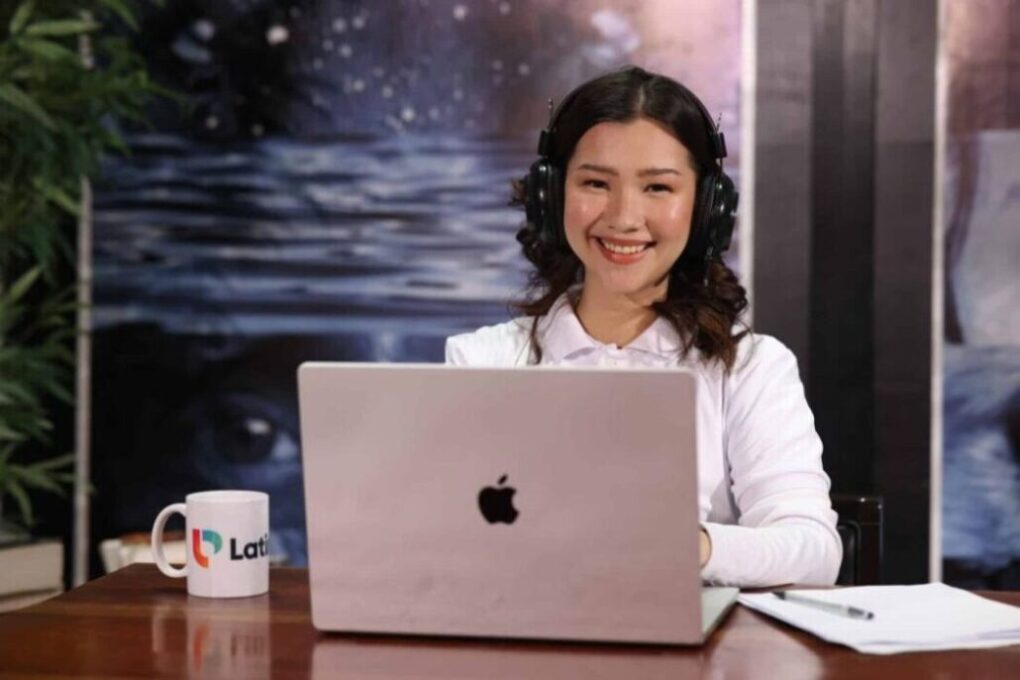 Happy woman pointing and winking, highlighting the benefits of virtual legal assistant services.