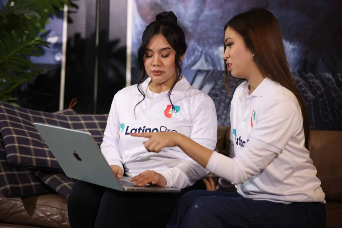 Legal and administrative assistant team from LatinoPro collaborating on tasks using a laptop in a remote work setting.