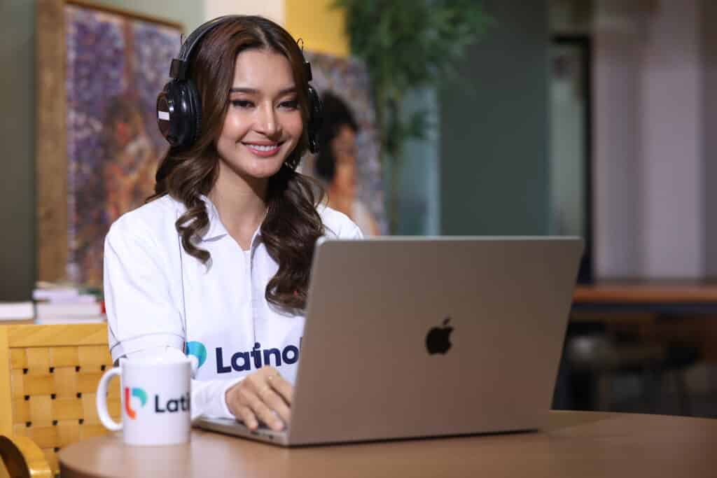 Legal and administrative assistant working remotely on a laptop, wearing a headset in a professional office setting.