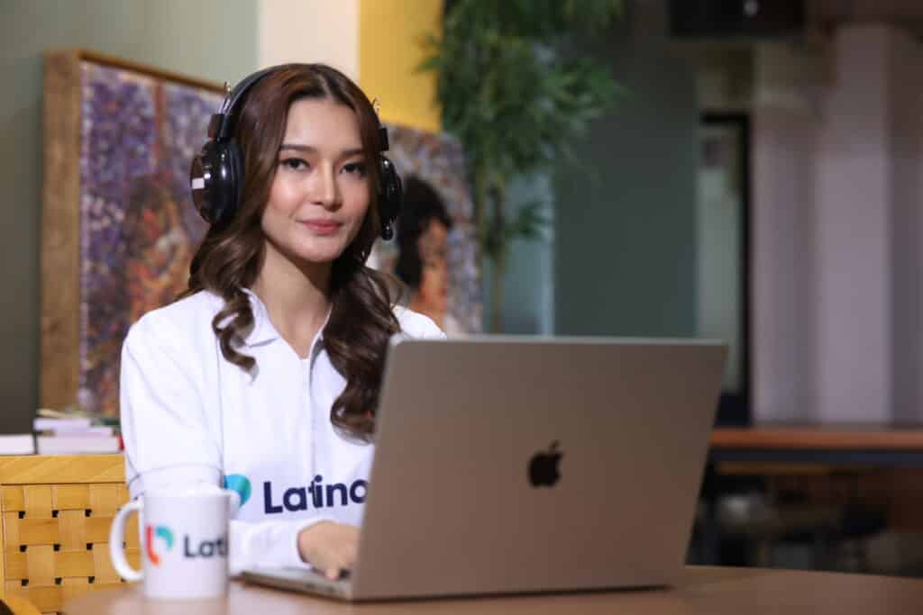 Professional woman on laptop comparing legal assistant vs legal secretary roles in a modern office setting.