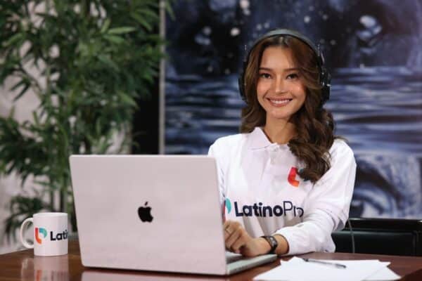 Smiling Legal Research Assistant with headphones on, working on a laptop. Legal Research Assistant service