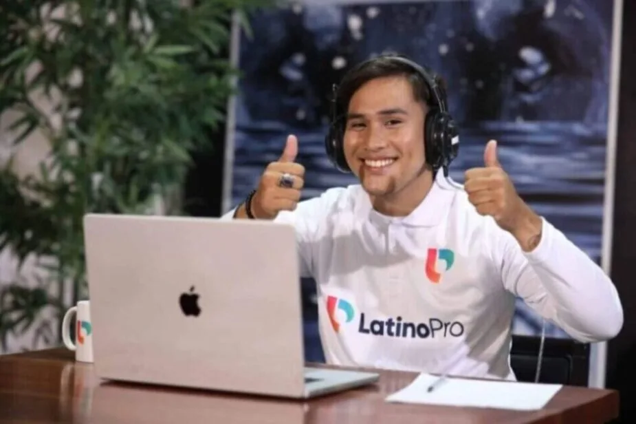 Smiling professional giving thumbs up while showcasing administrative assistant hard skills in a remote LatinoPro setup.