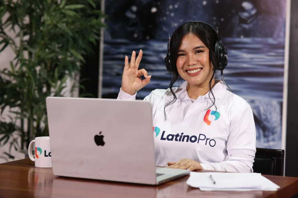 Smiling woman in headset and LatinoPro shirt on video call, illustrating what is a legal intake specialist in action.