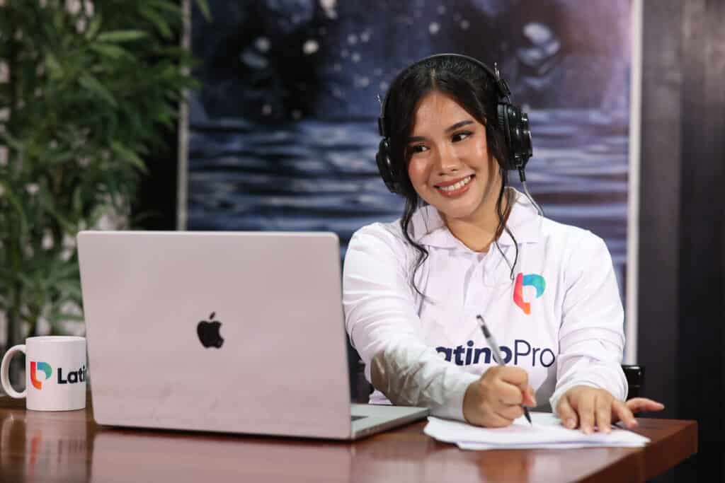 Smiling woman taking notes on laptop showing How Do Document Review Specialists Virtual Assistant Operate In Law Firms.