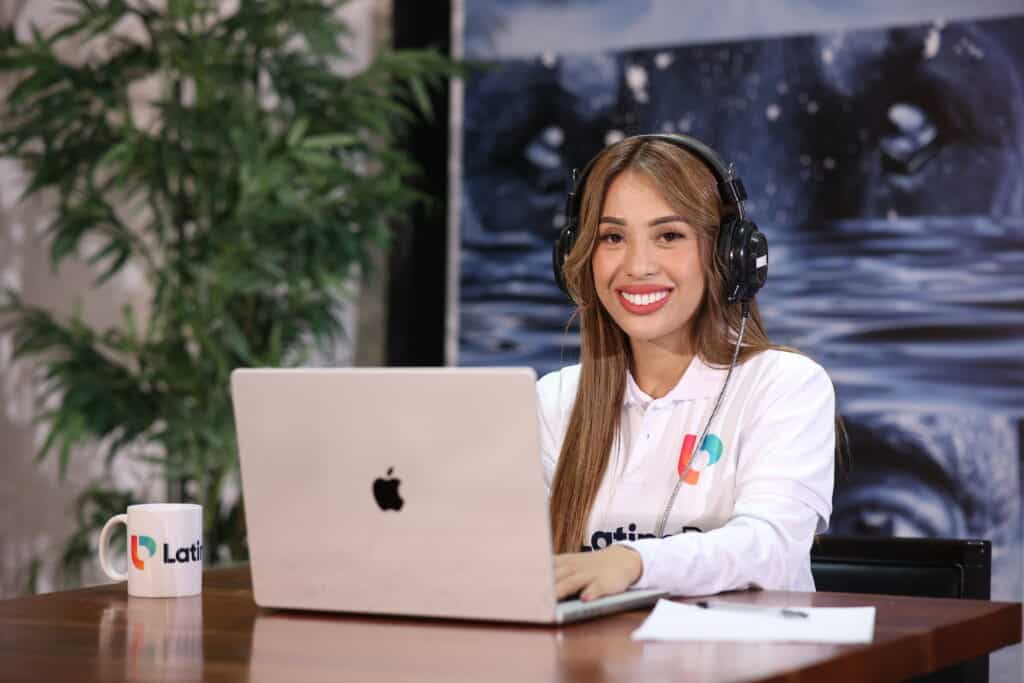 Smiling woman with headphones and laptop, showcasing capabilities for virtual case manager jobs.