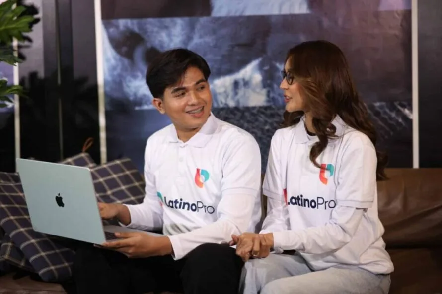 Two LatinoPro team members collaborating on a laptop, showing teamwork in what is a legal intake specialist role.