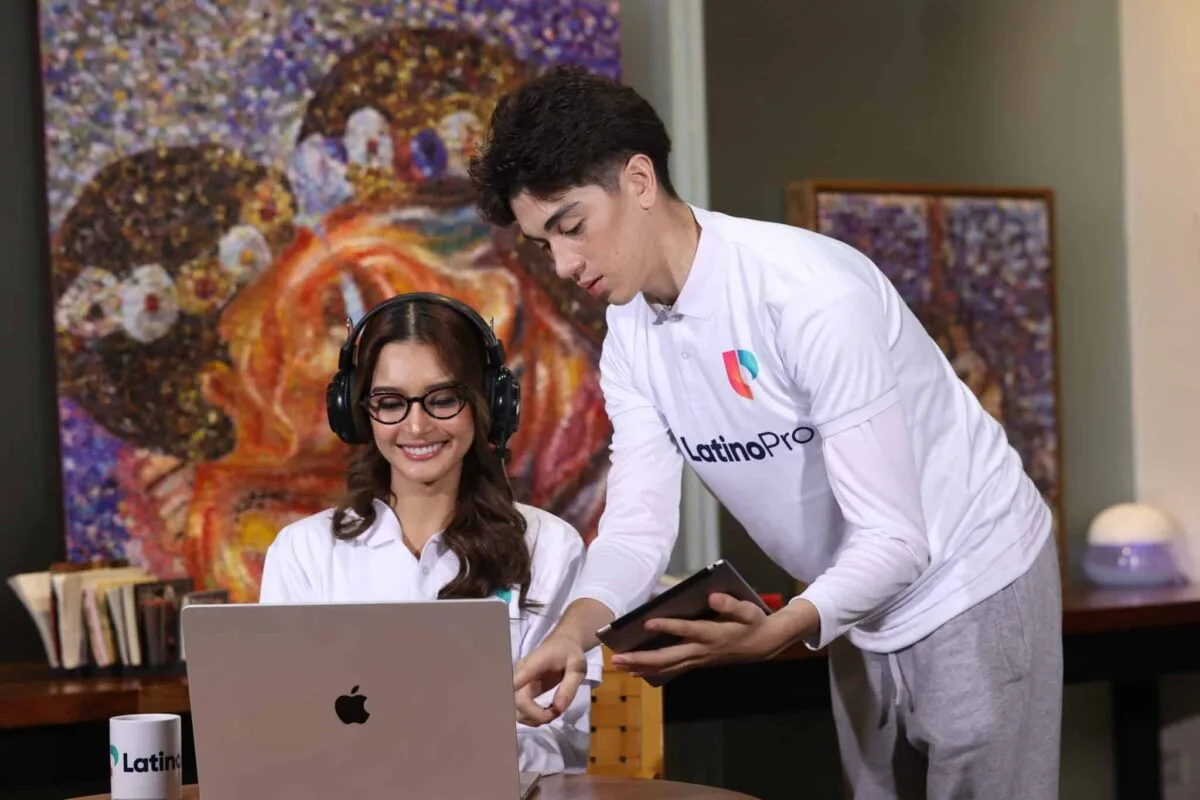 Two professionals collaborate on a laptop, highlighting legal assistant vs legal secretary roles in a modern workspace.