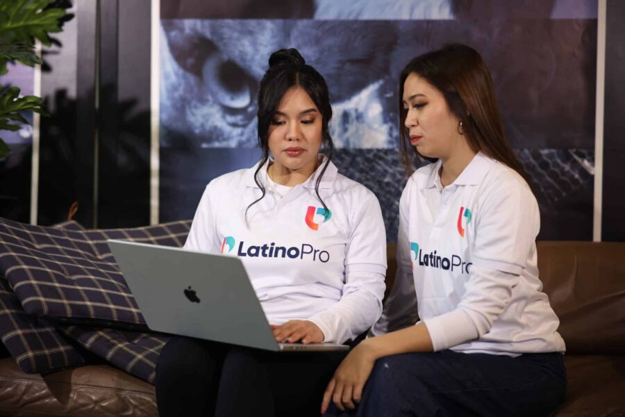 Two professionals collaborate on laptop, showing how do document review specialists virtual assistant operate in law firms.