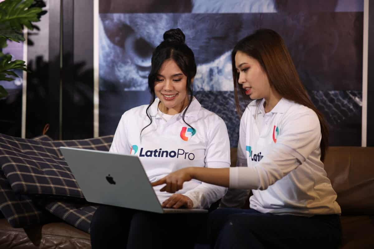 Two women from LatinoPro collaborating on a laptop, showcasing teamwork and support through virtual legal assistant services.