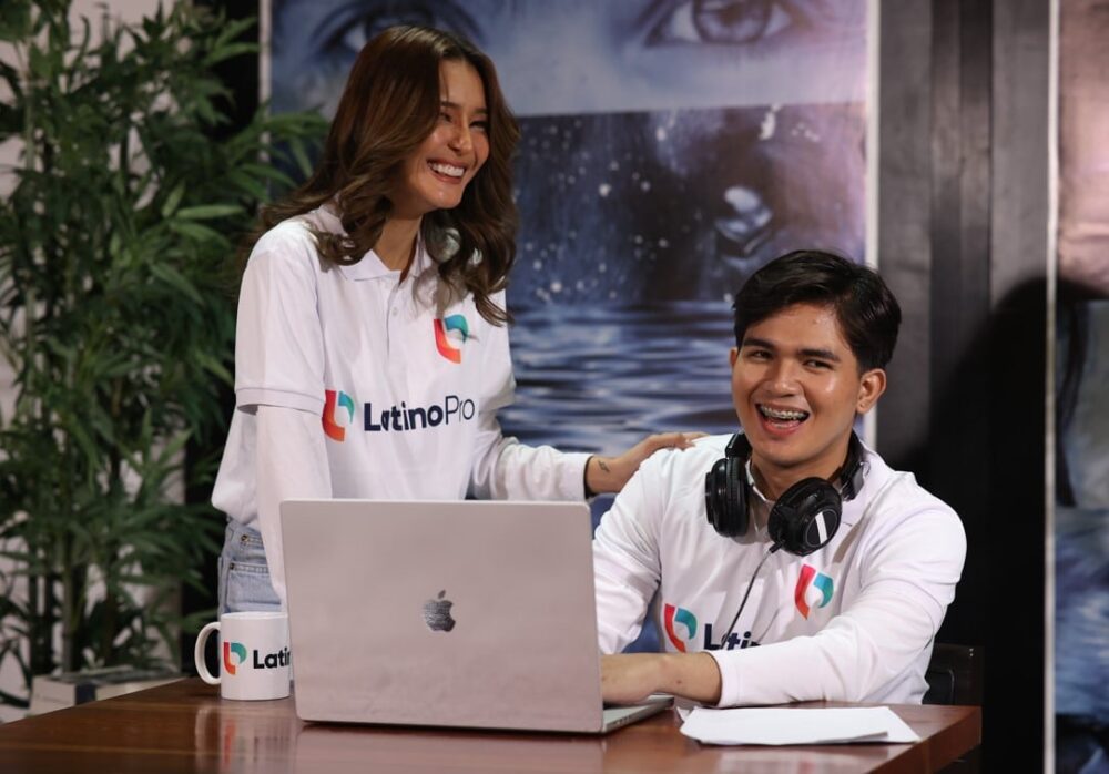 What does it take to be a legal assistant A man and woman with LatinoPro shirts smiling and working together