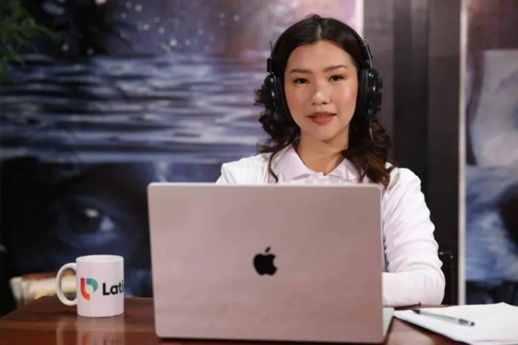 Woman in headset and LatinoPro shirt on video call, representing what is a legal intake specialist providing client support.