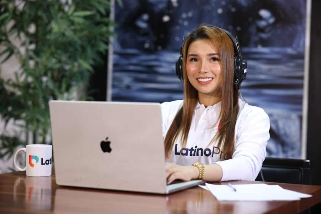 Woman in headset working remotely on laptop—great fit for illustrating a legal intake specialist job description page.
